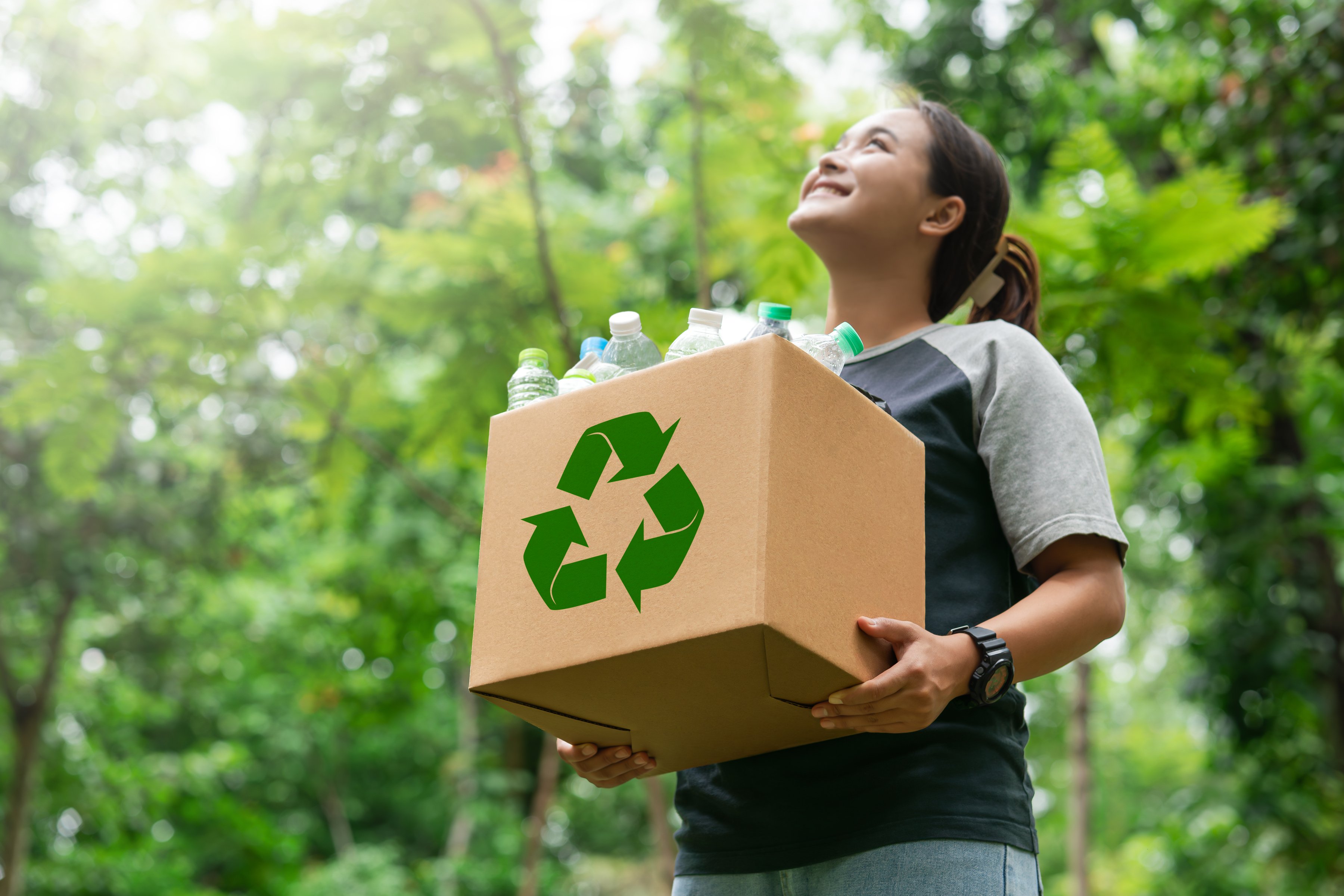 woman holding a garbage box recycling concept Recycle, recycle,